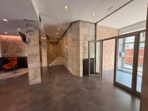 a lobby with a stone wall at The FLOOR in Milan