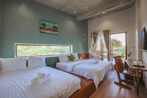 a bedroom with two beds with towels on them at DQ Peaceful Villa in Thôn Dương Xuân Hạ