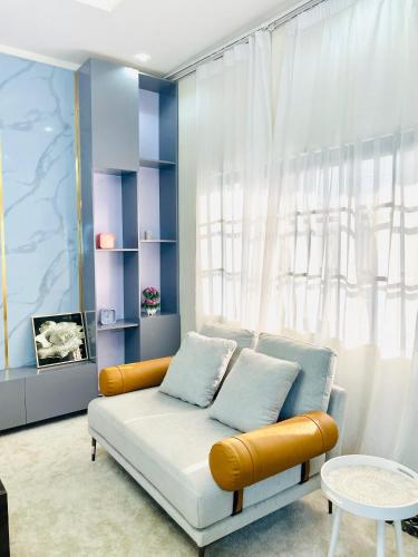a living room with a couch in front of a window at Westtzs Home I in Yaoundé