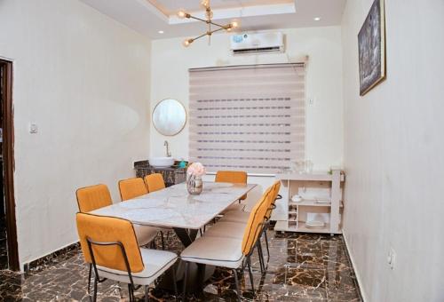 a dining room with a table and chairs at Westtzs Home I in Yaoundé