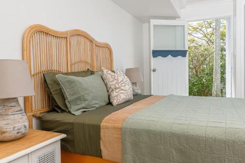 a bedroom with a bed and a window at The Palms in Redcliffe