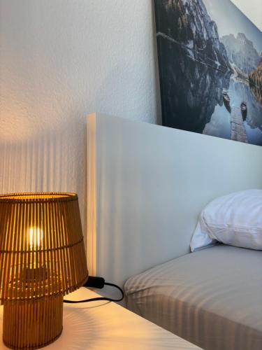 a bedroom with a bed and a lamp on a table at Comfortable Private Room in a Prime Location! HBF in Wolfsburg