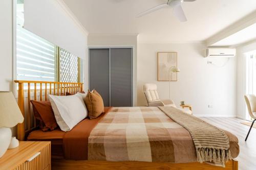 a bedroom with a large bed and a window at Margate Beach Studio 3 in Redcliffe