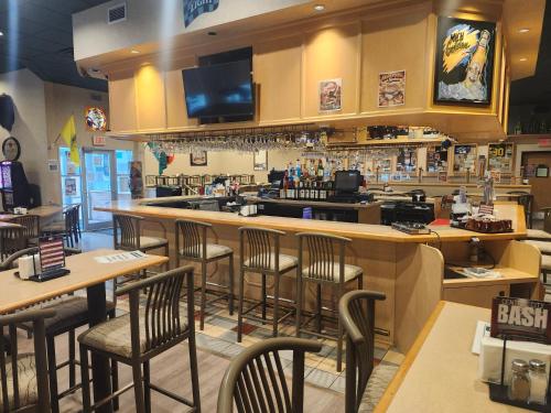 a bar in a restaurant with chairs and tables at Chieftain Conference Center in Carrington