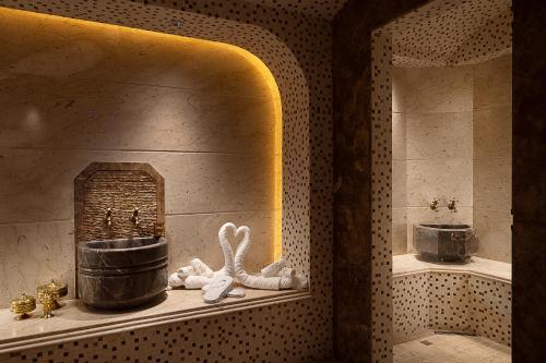 a bathroom with a sink and a bath tub at Hotel Supreme in El Biar