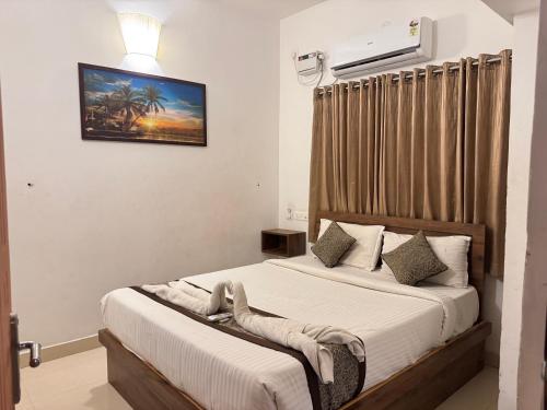 a bedroom with two beds and a picture on the wall at Le Poshe Suite - TIE Hotels in Pondicherry