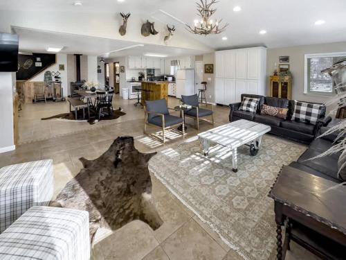 a living room with a couch and a table at MTN Meadow Retreat near PC in Peoa