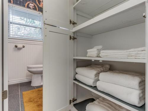 a bathroom with white towels and a toilet at Norman Home with Game Room in Norman