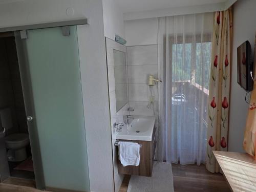 a bathroom with a sink and a mirror at Siegele - Top 1 in Kappl