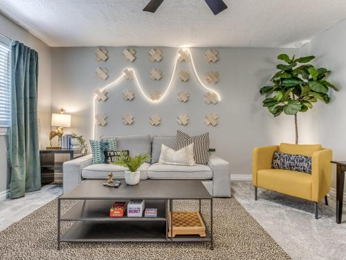 a living room with a couch and a chair at Norman Home with Game Room in Norman