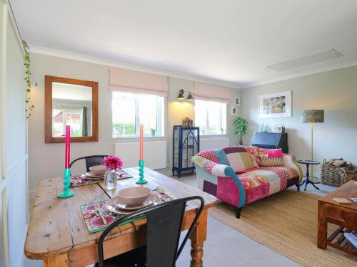 a living room with a table and a couch at The Annexe Shotley Cottage in Ipswich