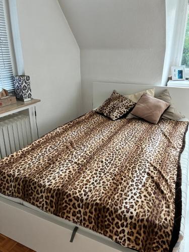 a bedroom with a bed with a leopard print at Studio Mel in Mülheim an der Ruhr