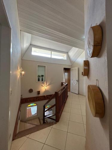 a large hallway with a skylight in a house at SkyBlue Guesthouse by Concavus in Campos do Jordão