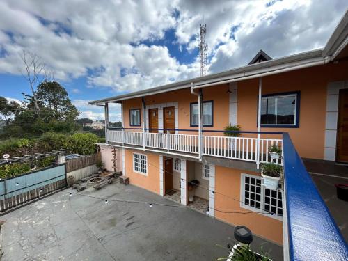 an image of a house with a balcony at SkyBlue Guesthouse by Concavus in Campos do Jordão