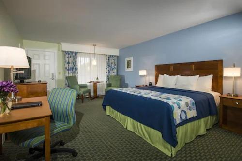 a hotel room with a bed and a desk at Ogunquit The Milestone Inn in Ogunquit
