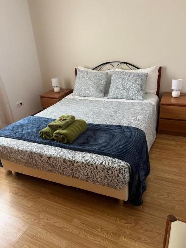 a bedroom with a bed with a blue blanket at Villa Abreu in Ponta do Sol