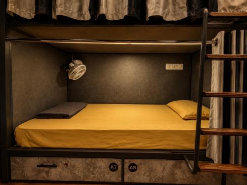 a bedroom with a bunk bed in a bunk room at Charyana Heights Ac Dormitory in Ahmedabad