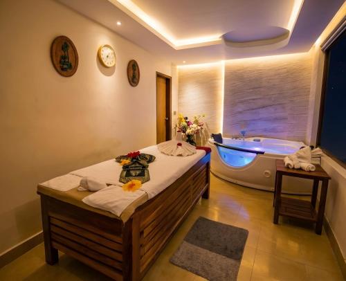 a bathroom with a bed and a bath tub at FARS Hotel & Resorts - BAR-Buffet-Pool-SPA in Dhaka