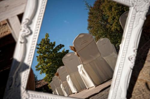 a mirror reflection of chairs in a white frame at Hotel Palacio de Elorriaga in Vitoria-Gasteiz
