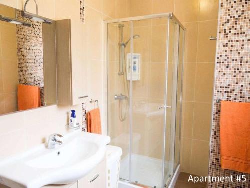 a bathroom with a shower and a sink at Riviera Holiday Apartments - Seafront - Wifi in Marsaskala
