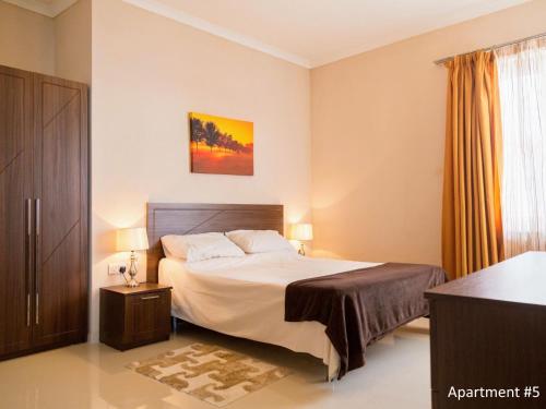 a bedroom with a large bed and a window at Riviera Holiday Apartments - Seafront - Wifi in Marsaskala