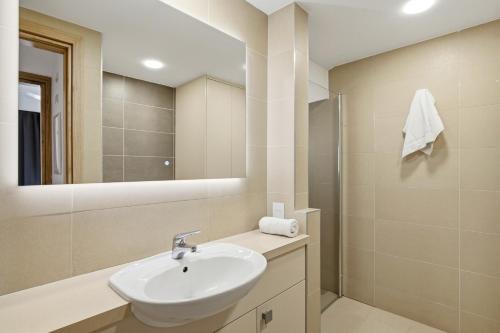 a bathroom with a sink and a mirror at Modern Villa HG08 Pyrinas with Amazing Golf Views, in heart of Aphrodite Hills in Kouklia