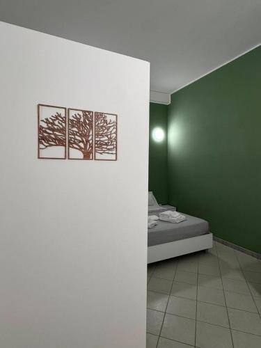a bedroom with two pictures of trees on the wall at Scirocco - ideale per coppie e famiglie in Carmiano