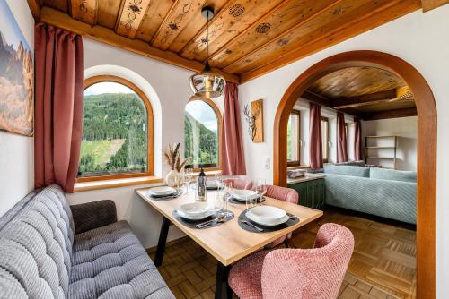 a dining room with a table and chairs at Chalet BergMoment - by myNests in Rohrmoos