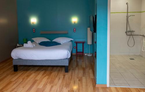 a bedroom with a bed and a bathroom with a shower at Logis - Hotel & Restaurant La Corne d 'Abondance in Bourgthéroulde