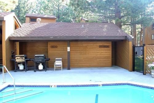 a garage with a grill and a swimming pool at Mountain Condo | Spa Pool and Ski Shuttle Access in Mammoth Lakes