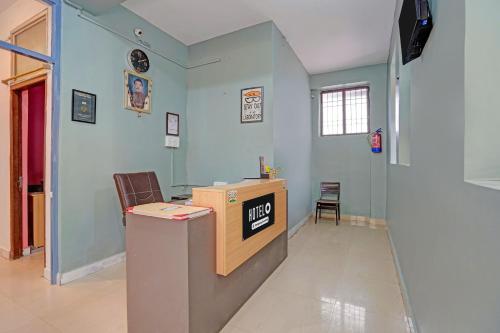 a waiting room with a desk and a chair at Super Hotel O AG Colony Park Patna Formerly Capital Pearl in Patna