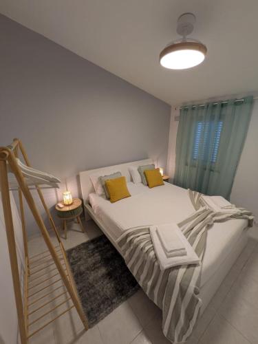 a bedroom with a large bed with yellow pillows at Casa Crisel in Aljezur