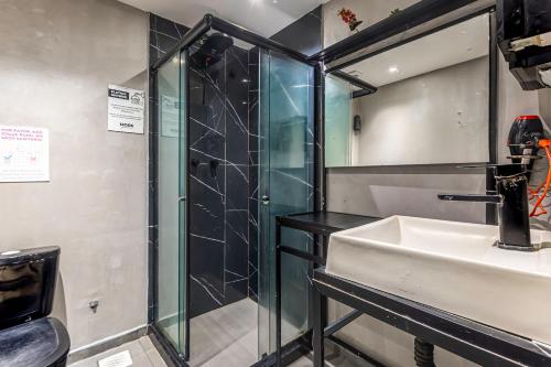 a bathroom with a sink and a shower at More Ipanema Hostel in Rio de Janeiro