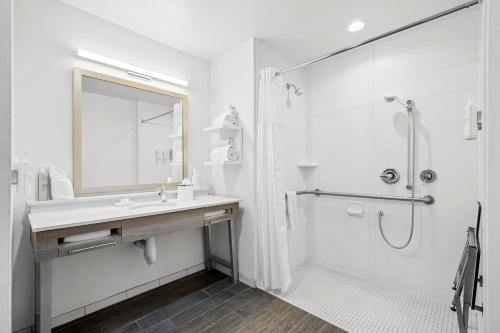 a white bathroom with a sink and a shower at Hampton Inn & Suites By Hilton Knightdale Raleigh in Raleigh