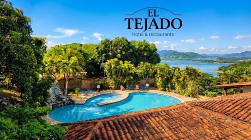 a resort pool with a view of the water at El Tejado in Suchitoto