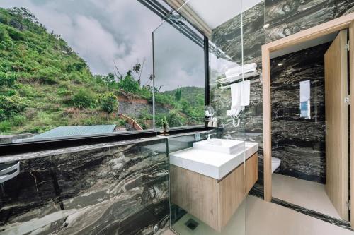 a bathroom with a sink and a mountain view at Cat Ba Vista Luxury Hotel - New 2026 - Rooftop Infinity Pool in Cat Ba
