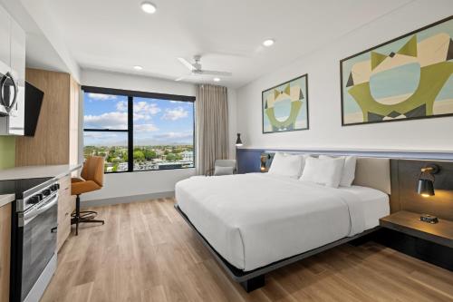 a hotel room with a bed and a large window at The 233 Suites Unscripted By Hyatt in Mesa