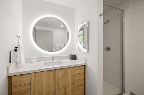 a bathroom with a sink and a mirror at The 233 Suites Unscripted By Hyatt in Mesa
