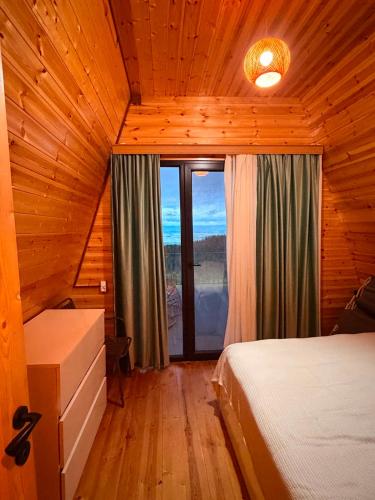 a bedroom with two beds and a large window at Alpase Resort in Didi Khalebi