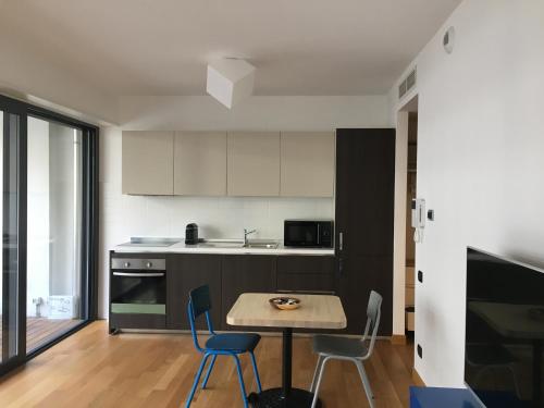 a kitchen with a table and chairs in a room at Loft Giulietta in Milan