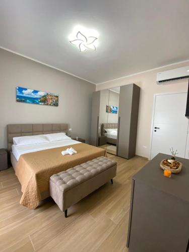 a bedroom with a large bed and a couch at Perla Blu House in La Spezia