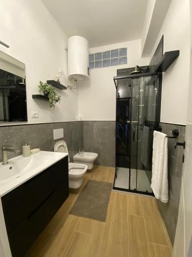 a bathroom with a toilet and a sink and a shower at Perla Blu House in La Spezia