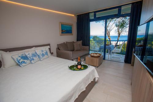 a bedroom with a bed with a view of the ocean at Sounio Sea View in Sounio