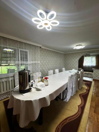 a large dining room with a large white table with chairs at Guest House Sveta in Saty
