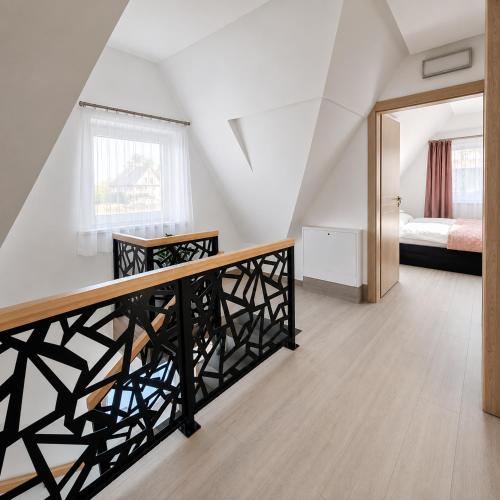 a room with a staircase with a bed and a mirror at Grafitowe Apartamenty in Czarna Góra