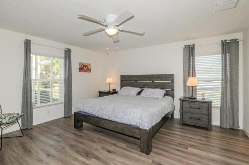 a bedroom with a bed and a ceiling fan at Withlacoochee Trail Getaway - Private Pool - 3bedrooms in Inverness
