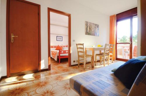 a bedroom with a table and a dining room at Appartamenti Splendid E Salisburgo in Bibione