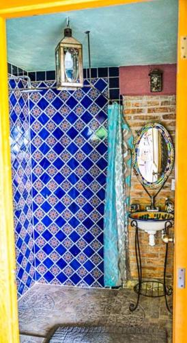 a bathroom with a sink and a mirror at Lovely garden flat with stunning mountain views in Alcocer