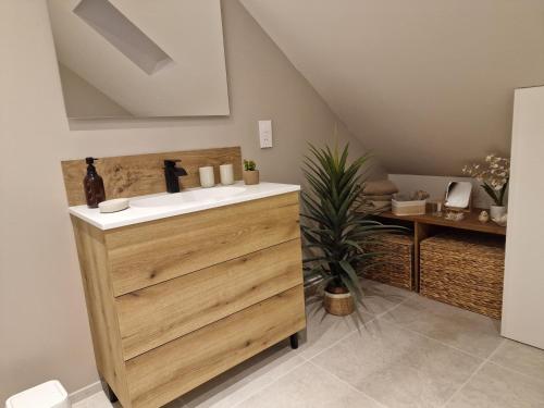 a bathroom with a sink and a table at Cap Ouest in Fécamp