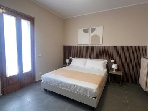 a bedroom with a bed with a wooden headboard at Da Paola 